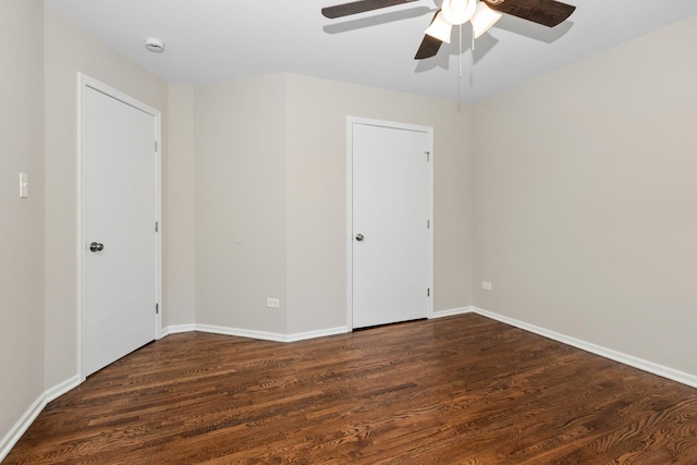 spare room with ceiling fan and dark hardwood / wood-style flooring