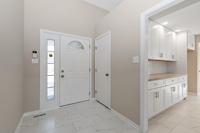 foyer with marble finish floor, baseboards, visible vents, and recessed lighting