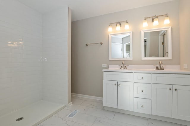 bathroom featuring vanity and a tile shower