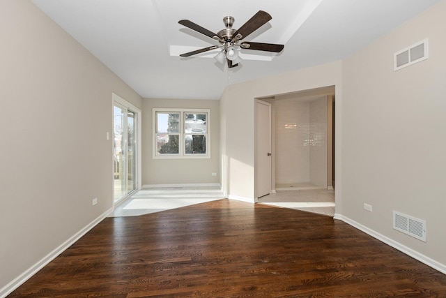 empty room with visible vents, baseboards, and wood finished floors