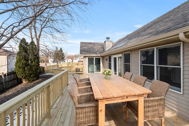 deck featuring outdoor dining area and fence