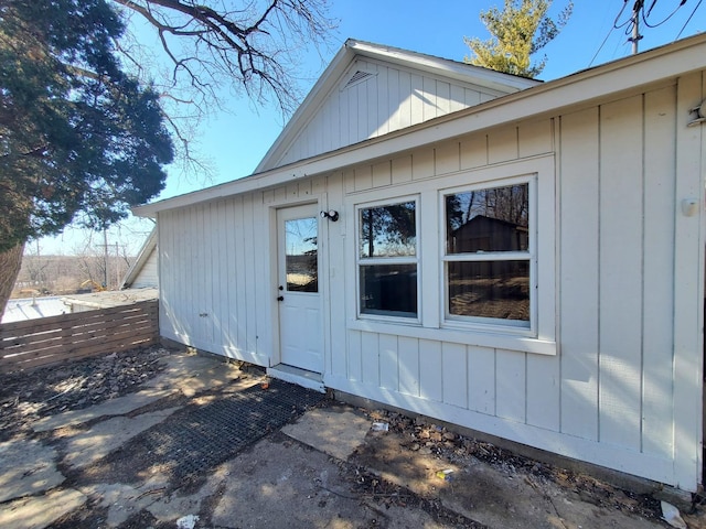 view of exterior entry featuring board and batten siding