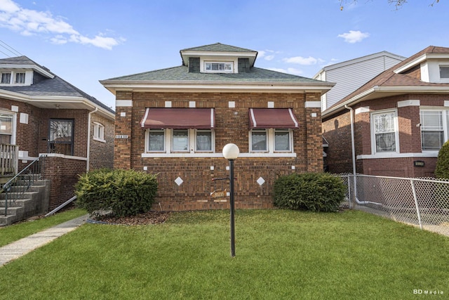 bungalow-style house with a front lawn