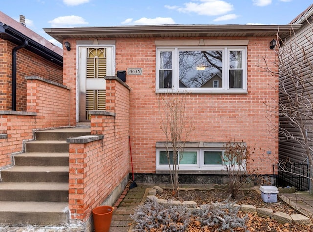 view of side of property featuring brick siding