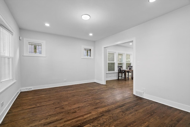 empty room featuring dark hardwood / wood-style flooring