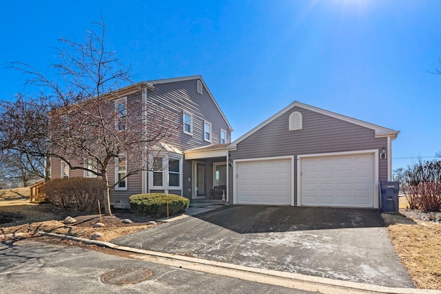 view of front of home with aphalt driveway and an attached garage