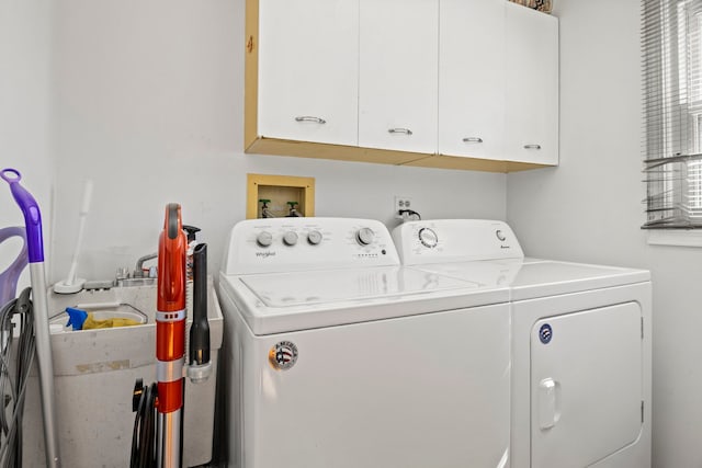 laundry room with washer and clothes dryer and cabinet space