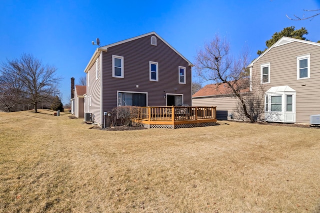 rear view of house featuring a lawn, a deck, and central air condition unit