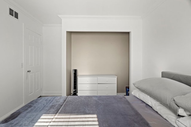 unfurnished bedroom featuring carpet floors, baseboards, visible vents, and crown molding