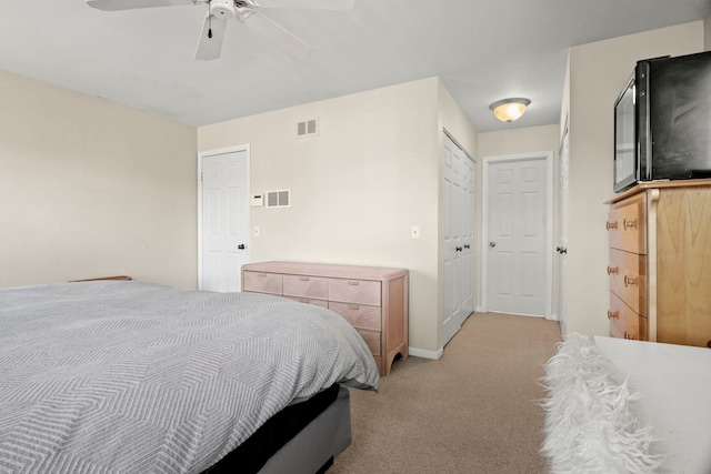 bedroom featuring a ceiling fan, light colored carpet, visible vents, and baseboards