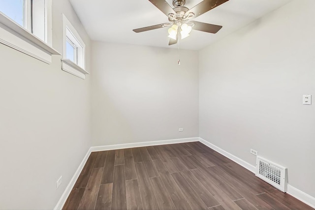 empty room with dark hardwood / wood-style floors and ceiling fan