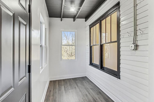 interior space featuring hardwood / wood-style floors, wooden ceiling, and beamed ceiling