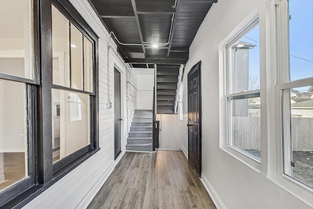 hall with hardwood / wood-style flooring