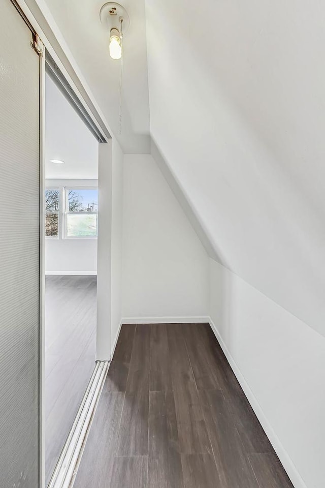 bonus room with dark hardwood / wood-style flooring and lofted ceiling