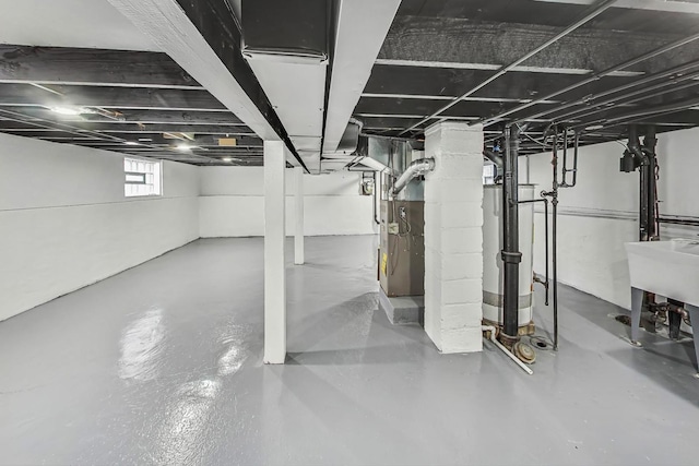 basement with gas water heater and heating unit