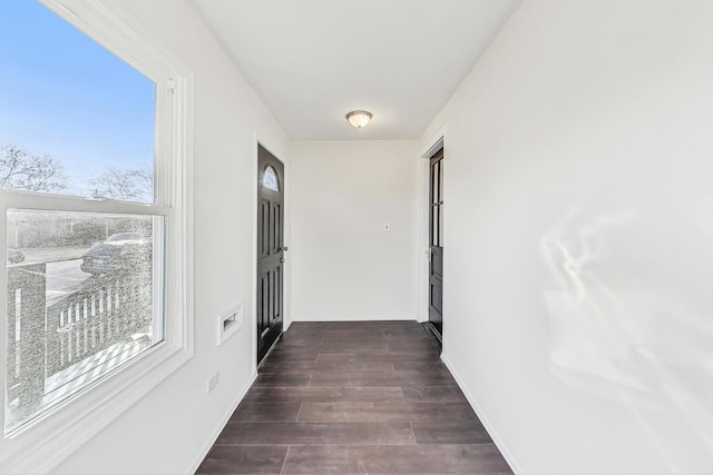 corridor with dark hardwood / wood-style flooring