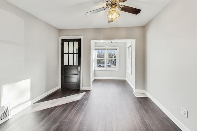 unfurnished room with dark hardwood / wood-style floors and ceiling fan