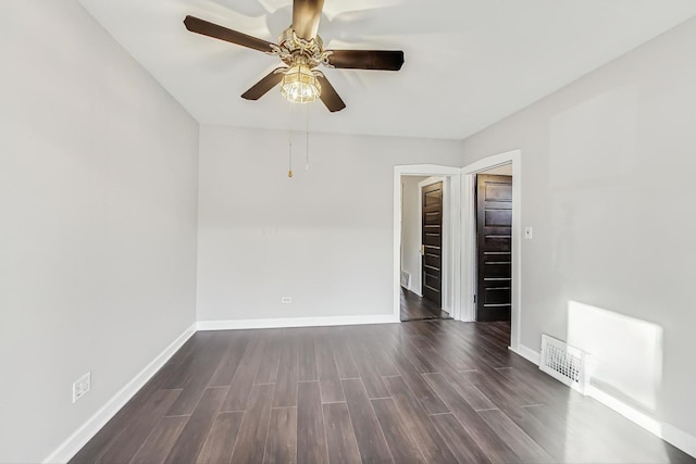 unfurnished room featuring dark wood-type flooring and ceiling fan