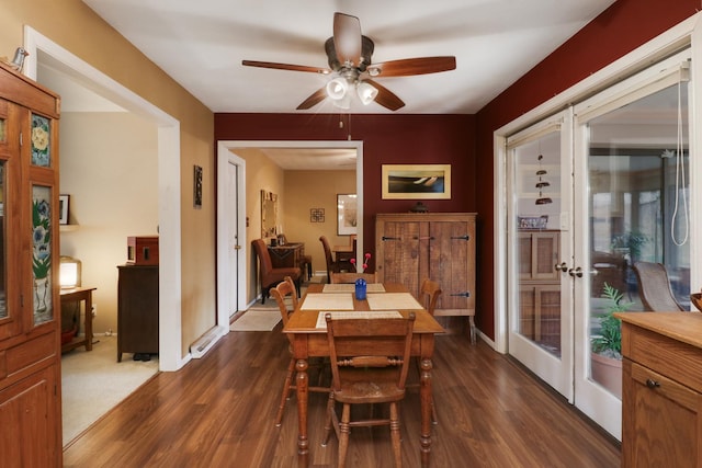 dining area featuring baseboards, a ceiling fan, and dark wood-type flooring