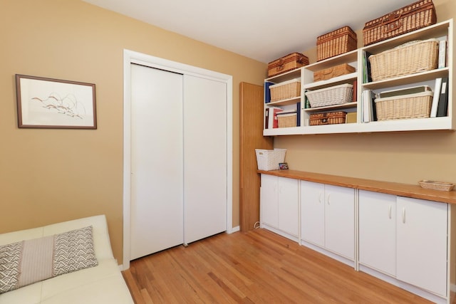 unfurnished bedroom with a closet and light wood-style floors