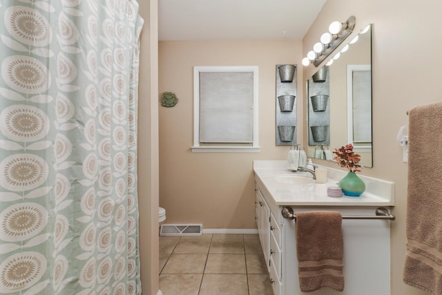 full bathroom featuring baseboards, visible vents, toilet, vanity, and tile patterned floors