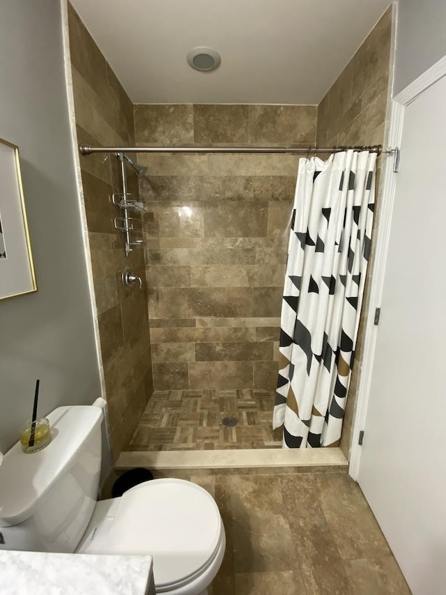 bathroom with toilet and a shower stall