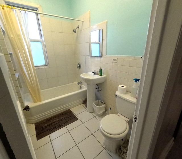 full bathroom with toilet, sink, tile walls, shower / bath combo, and tile patterned flooring