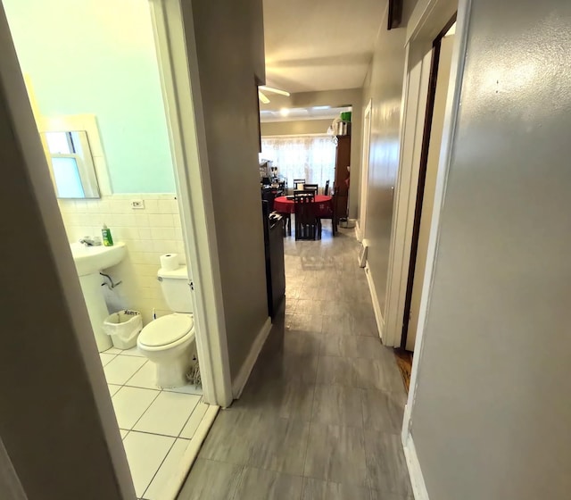 hall featuring tile walls and tile patterned floors