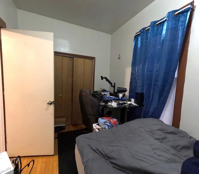 bedroom featuring a closet and light wood-type flooring