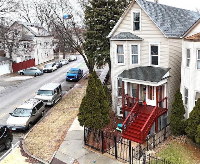 view of side of home featuring covered porch