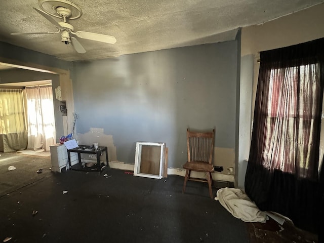 miscellaneous room featuring ceiling fan and a textured ceiling