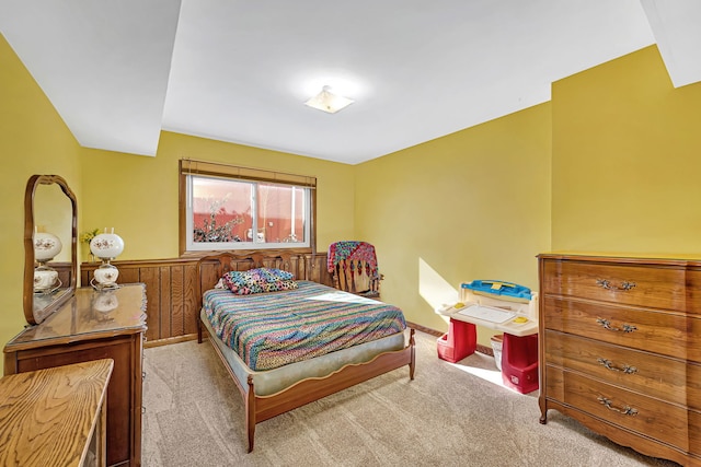 carpeted bedroom with wood walls