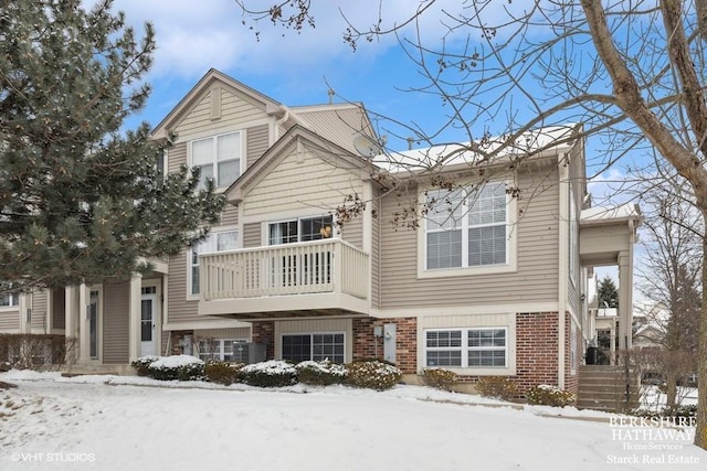 view of front of home with central air condition unit and brick siding