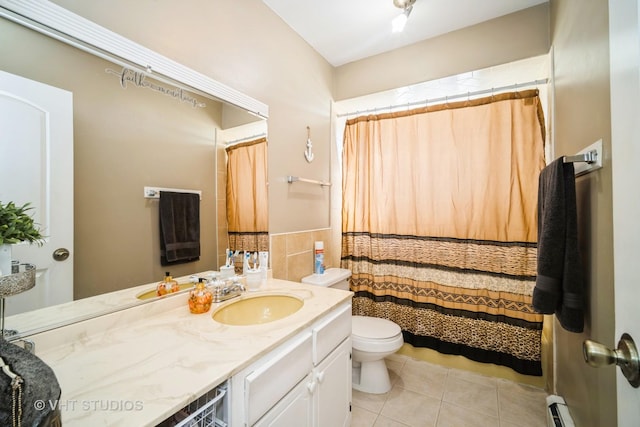 bathroom with a baseboard heating unit, toilet, vanity, and tile patterned flooring