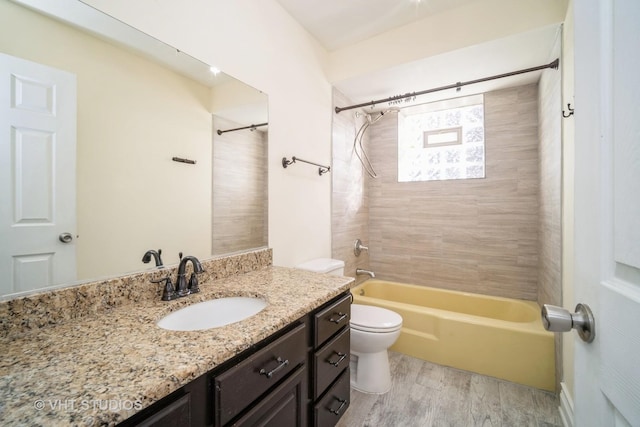 bathroom with vanity, shower / tub combination, toilet, and wood finished floors