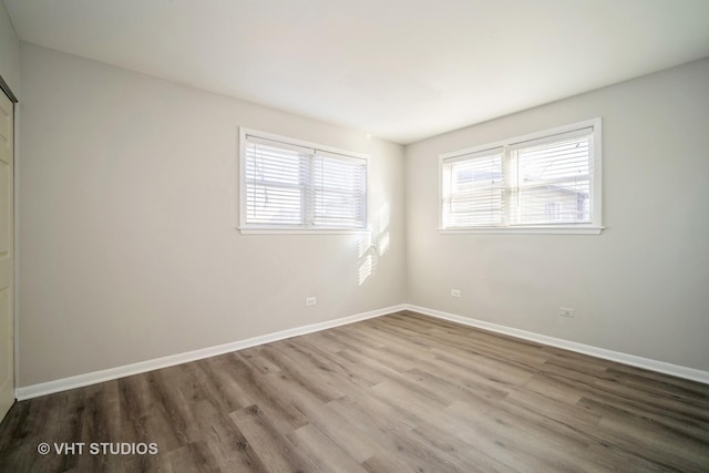 unfurnished room featuring wood finished floors and baseboards