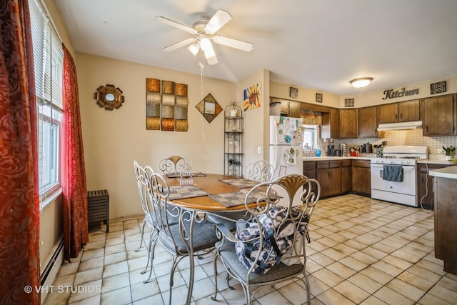 dining room featuring light tile patterned floors, a ceiling fan, and a baseboard radiator