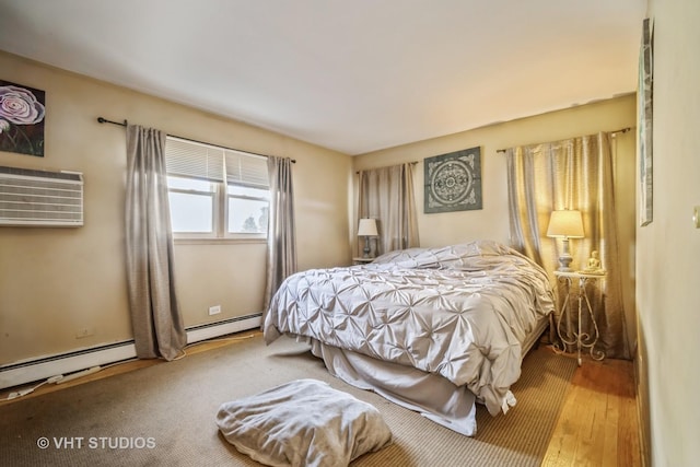 bedroom featuring an AC wall unit and a baseboard radiator