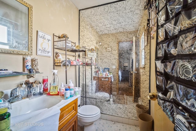 bathroom with vanity, tile patterned floors, toilet, and walk in shower