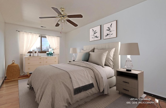 bedroom featuring visible vents, light wood-style floors, and a ceiling fan