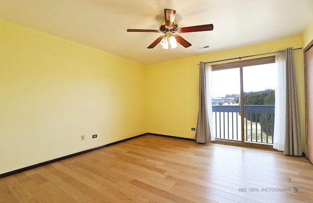 spare room with visible vents, baseboards, a ceiling fan, and light wood finished floors