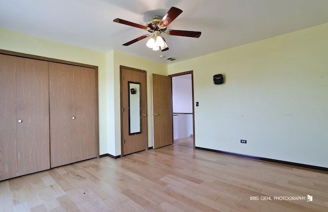 unfurnished bedroom featuring a closet, visible vents, light wood-type flooring, and baseboards