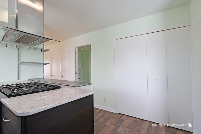 kitchen with island exhaust hood, range with gas cooktop, baseboards, and dark wood-style floors