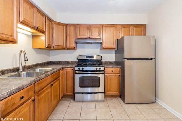 kitchen with appliances with stainless steel finishes, sink, and light tile patterned floors