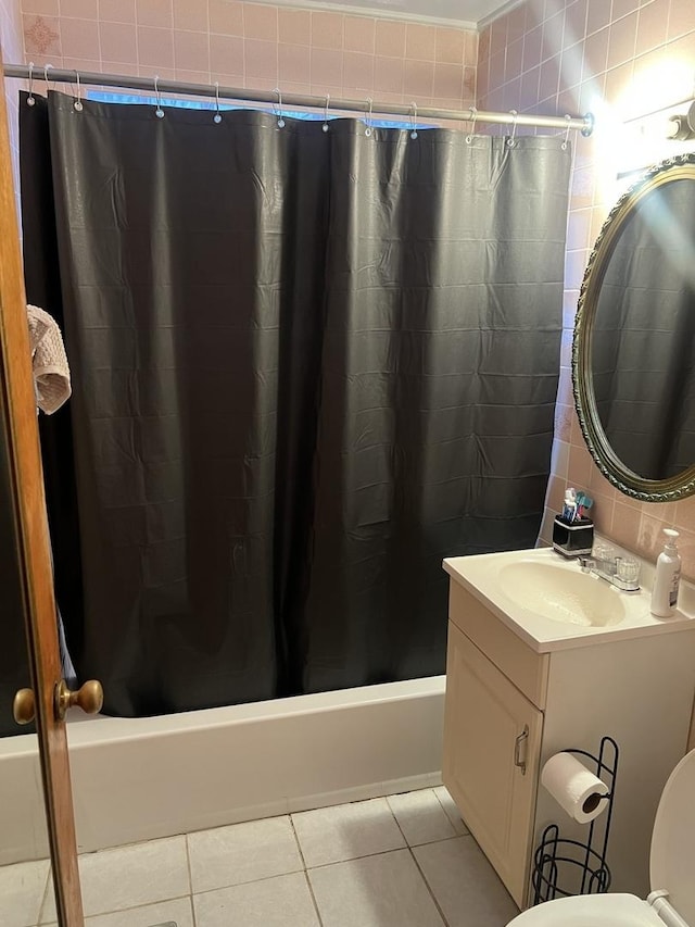 full bathroom with tile patterned flooring, vanity, tile walls, and shower / bathtub combination with curtain