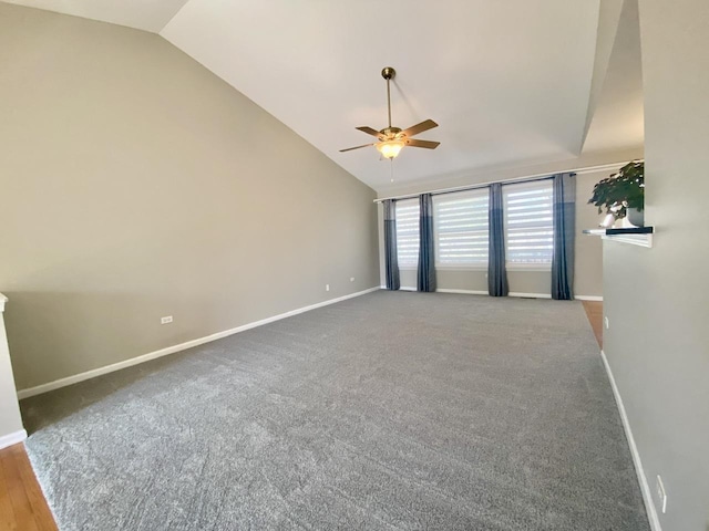 unfurnished room with baseboards, lofted ceiling, and ceiling fan