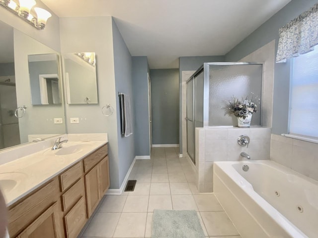 bathroom with tile patterned floors, visible vents, a stall shower, and a sink