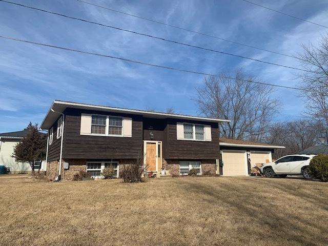 bi-level home with a garage and a front yard