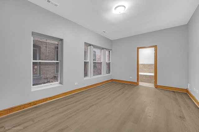 empty room with light hardwood / wood-style floors