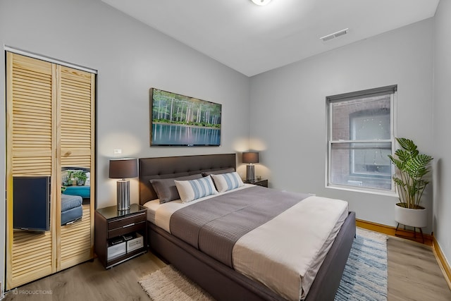 bedroom featuring light hardwood / wood-style floors and a closet